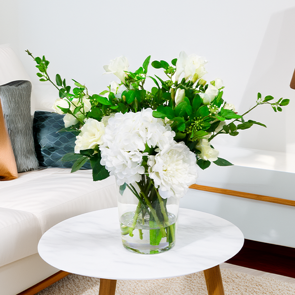 MIXED WHITE FLOWERS IN BUCKET GLASS VASE