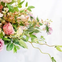 D332 MIXED PINKS IN PEDASTAL URN VASE