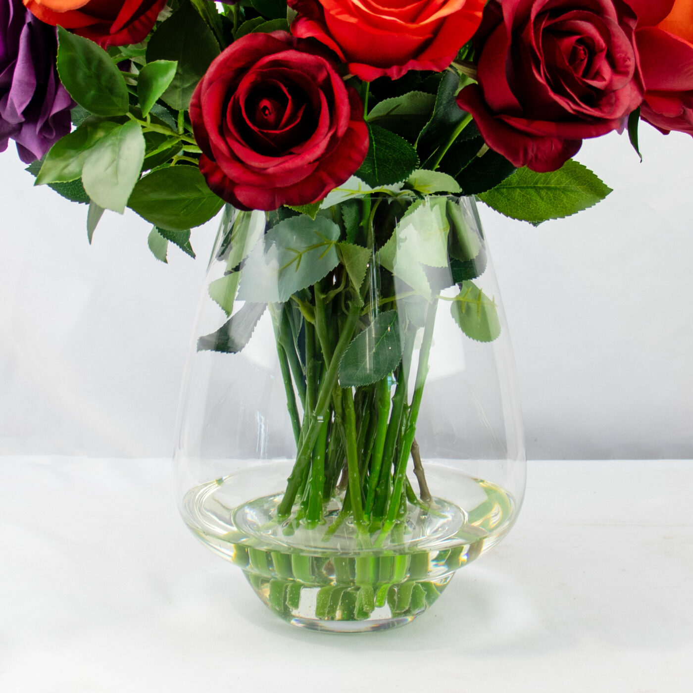 ROSES RED BEAUTY AND PURPLE IN GLASS VASE