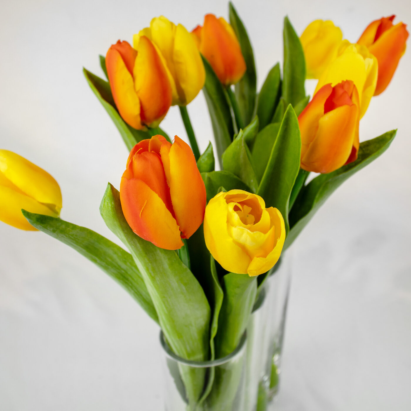 TULIPS YELLOW AND PINK IN RECTANGULAR GLASS VASE