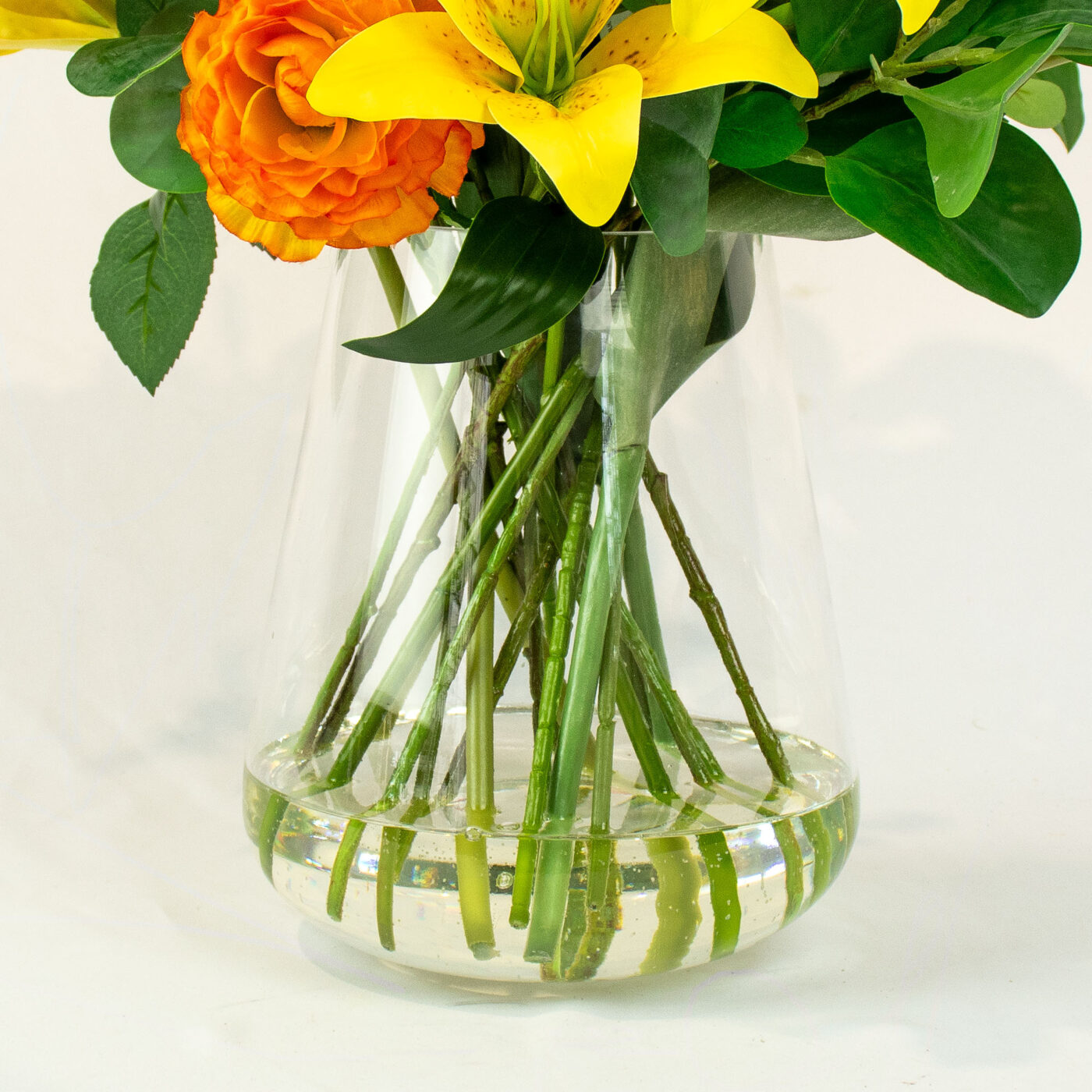 LILY RANUNCULUS ROSE ORANGE AND YELLOW IN GLASS VASE