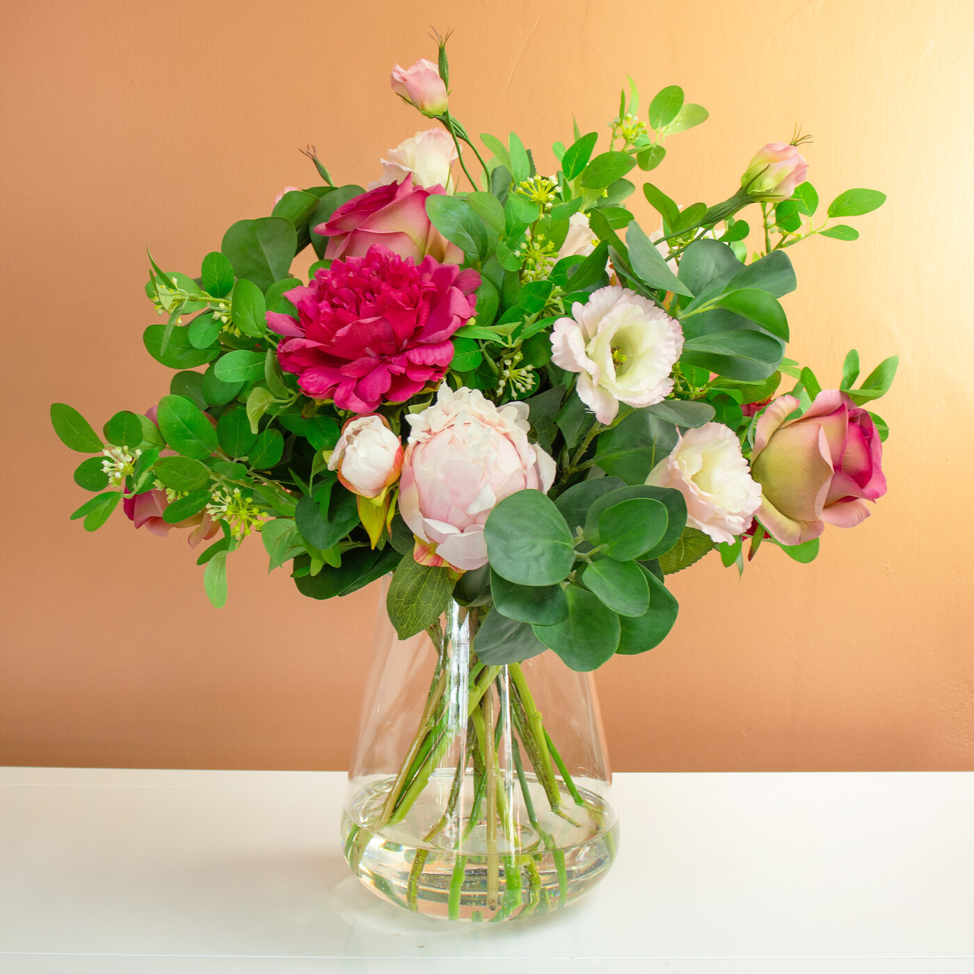 PEONY AND ROSE PINK WITH FOLIAGE IN GLASS VASE