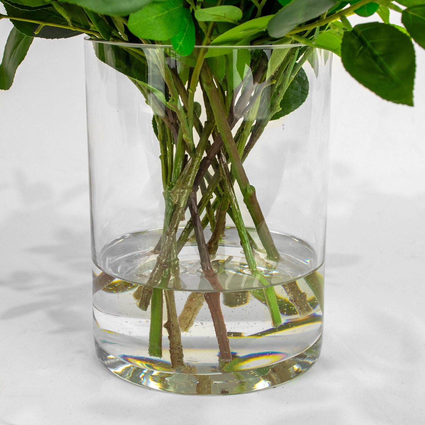 BANKSIA FUCHSIA WITH FOLIAGE IN GLASS VASE