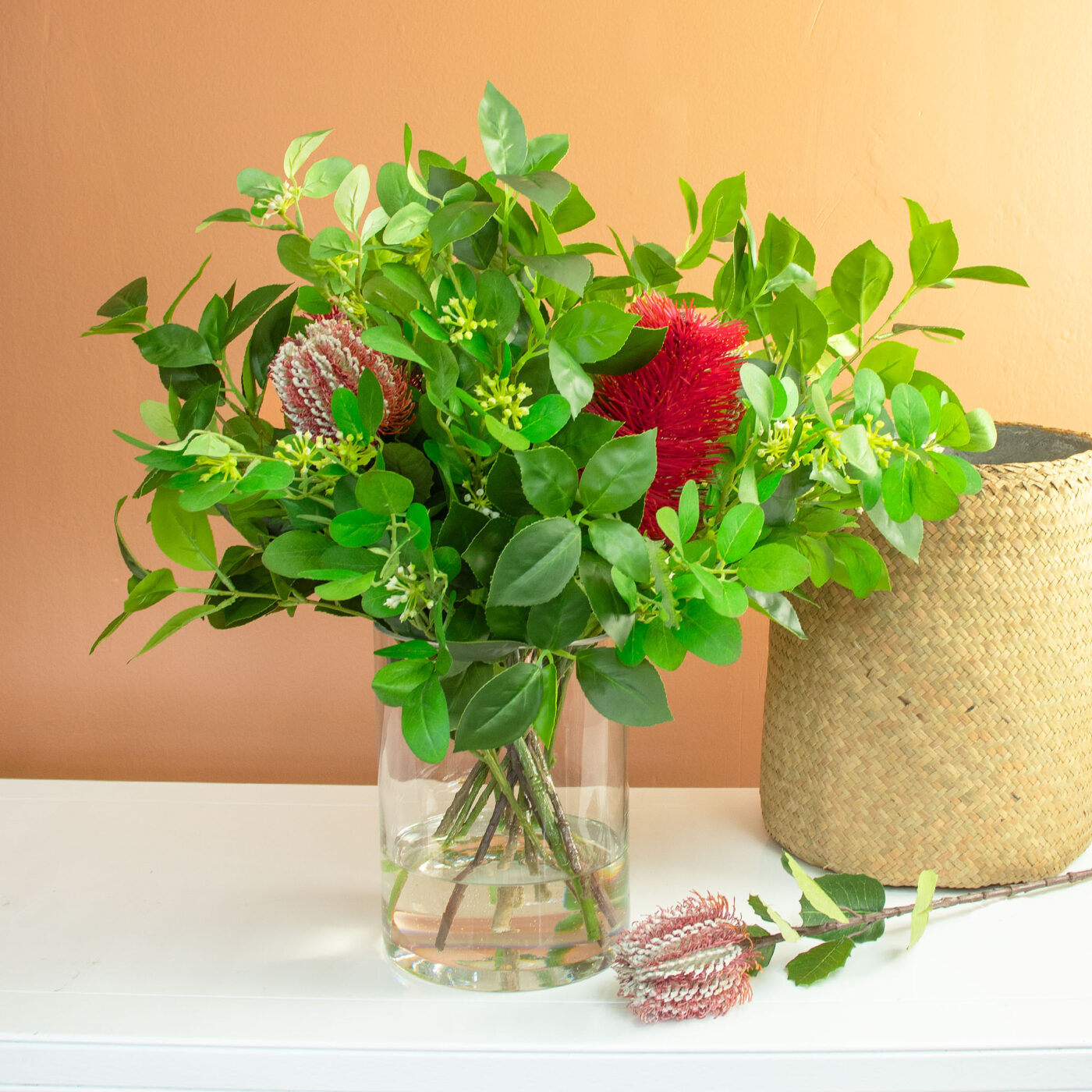 BANKSIA FUCHSIA WITH FOLIAGE IN GLASS VASE
