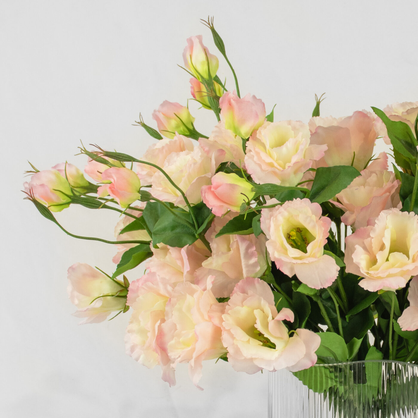 Pink Lavender Lisianthus flower arrangement set in a clear curved ribbed vase