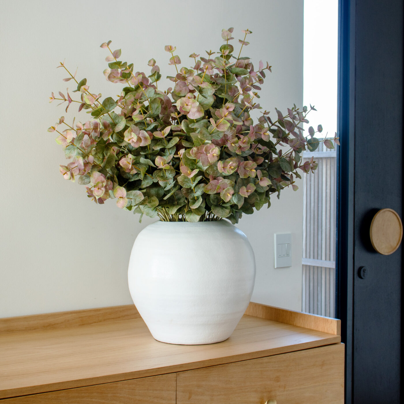 EUCALYPTUS SPRAY GREEN RED IN WHITE PLANTER