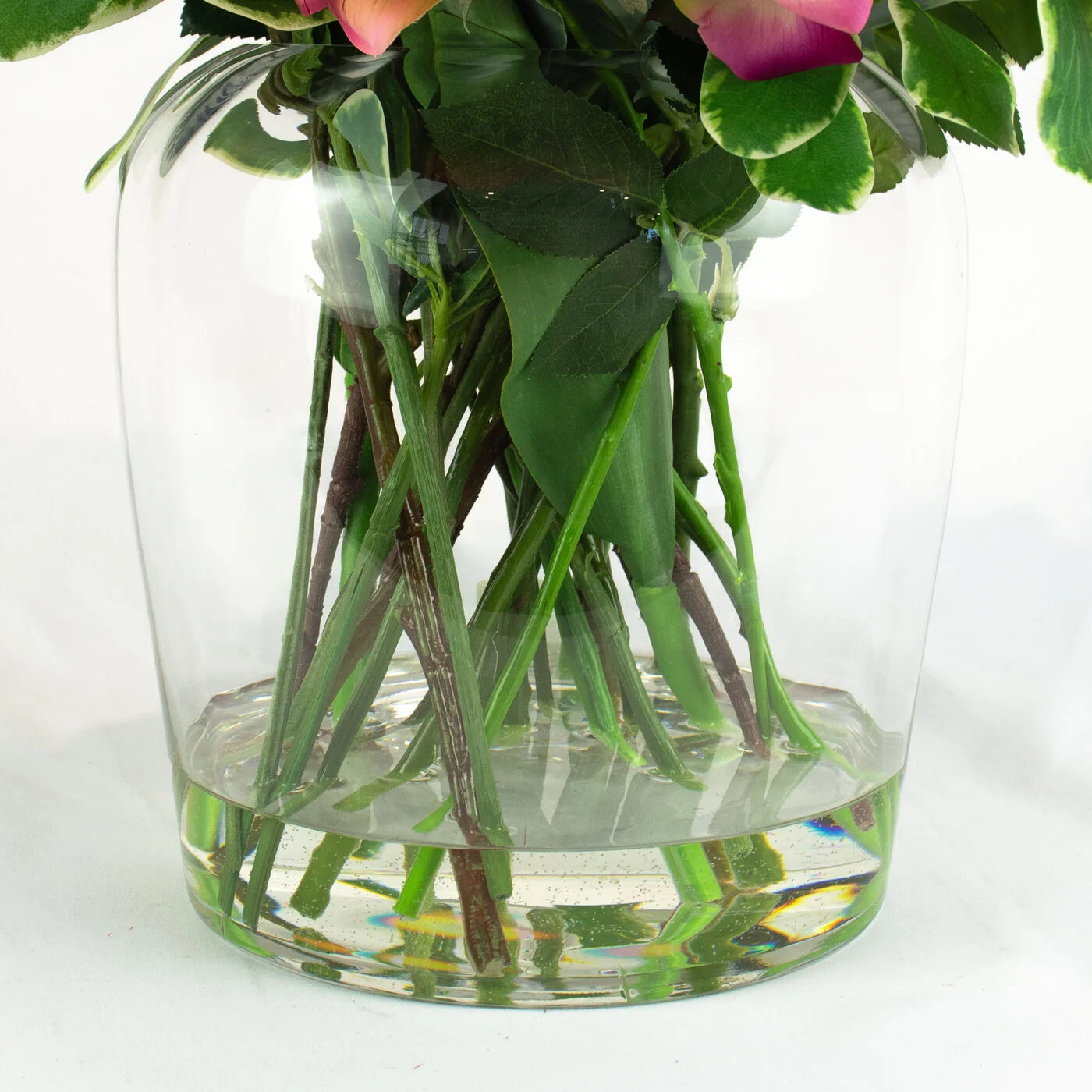 ROSES FUCHSIA AND PLUMS IN BARREL VASE