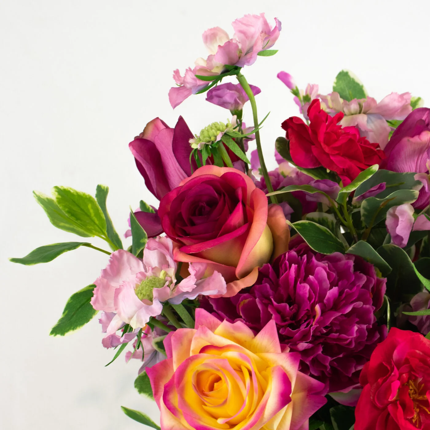 ROSES FUCHSIA AND PLUMS IN BARREL VASE