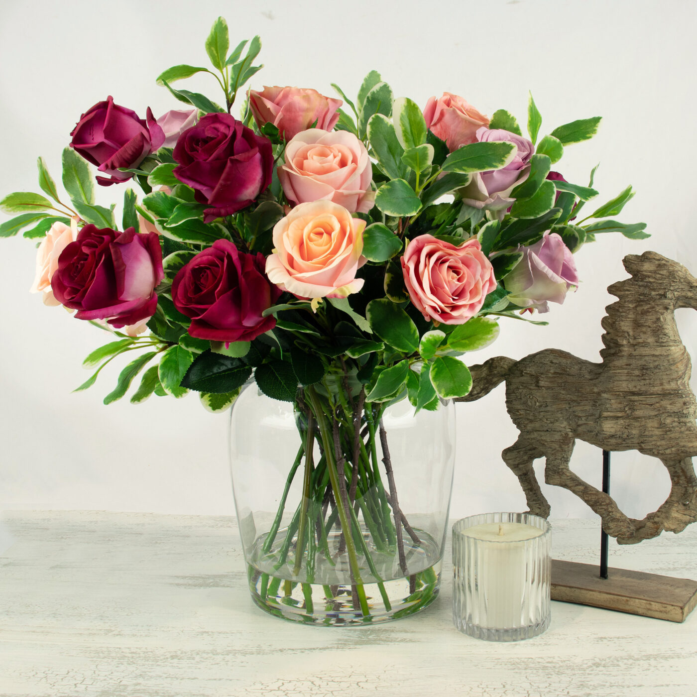 ROSES FUCHSIA WITH FOLIAGE IN BARREL VASE