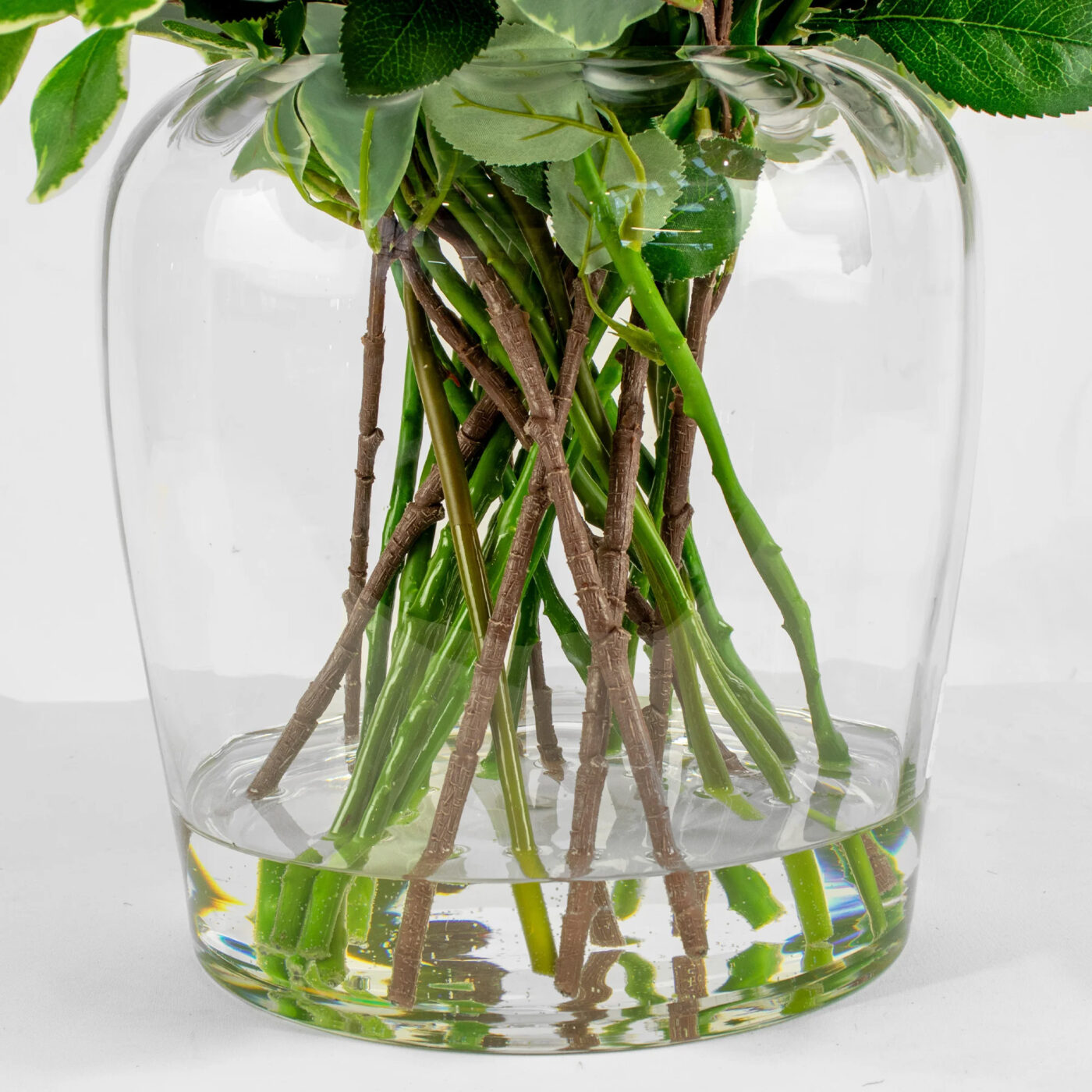 ROSES FUCHSIA WITH FOLIAGE IN BARREL VASE