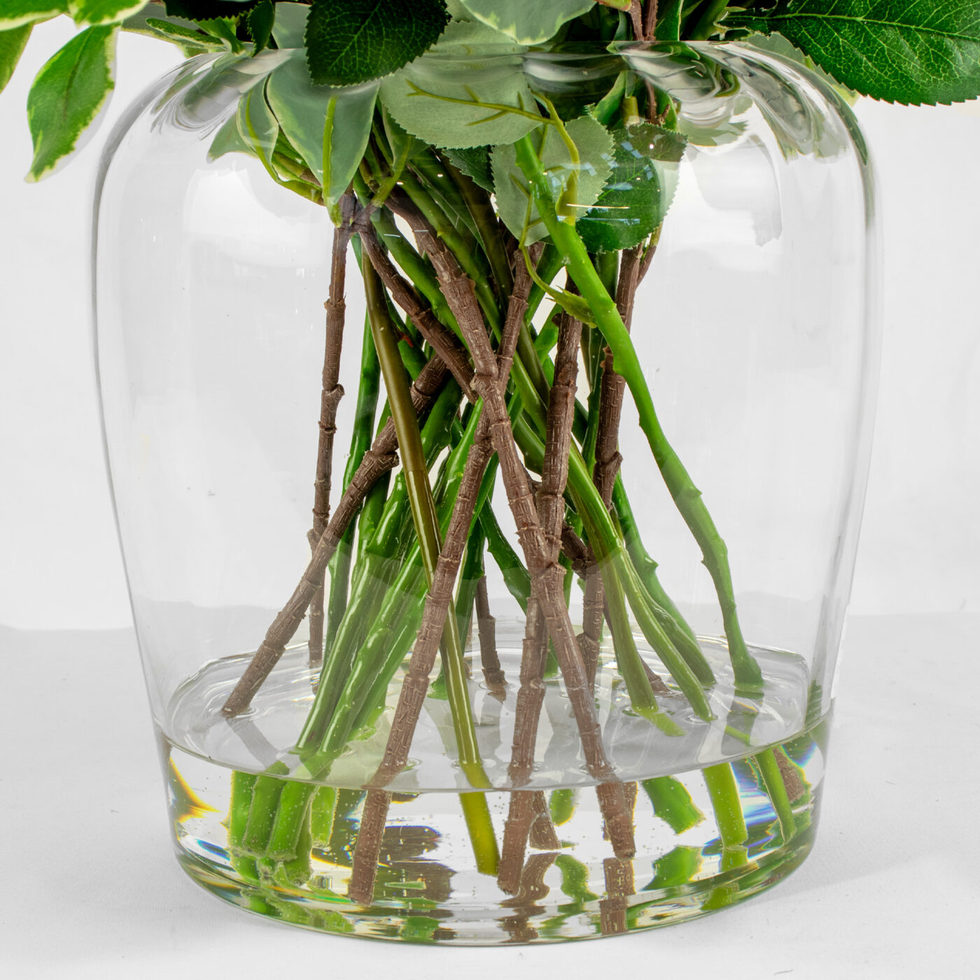ROSES FUCHSIA WITH FOLIAGE IN BARREL VASE
