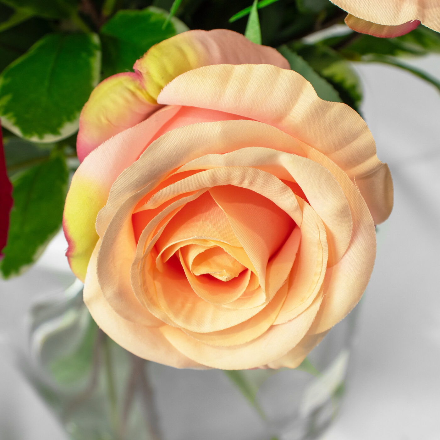 ROSES FUCHSIA WITH FOLIAGE IN BARREL VASE