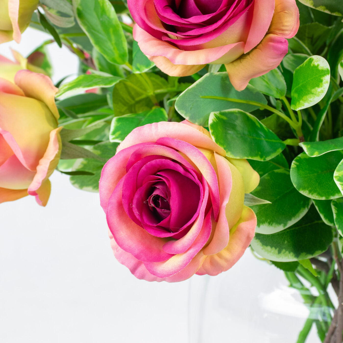 ROSES FUCHSIA WITH FOLIAGE IN BARREL VASE
