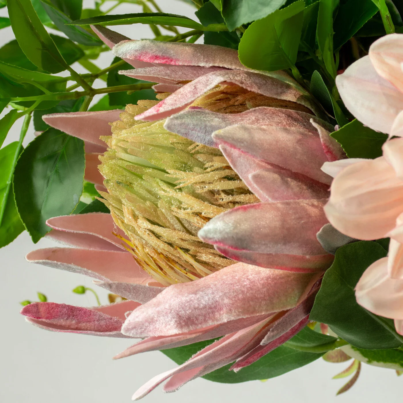DELUXE BLUSH PINKS WITH FOLIAGE IN GLASS VASE