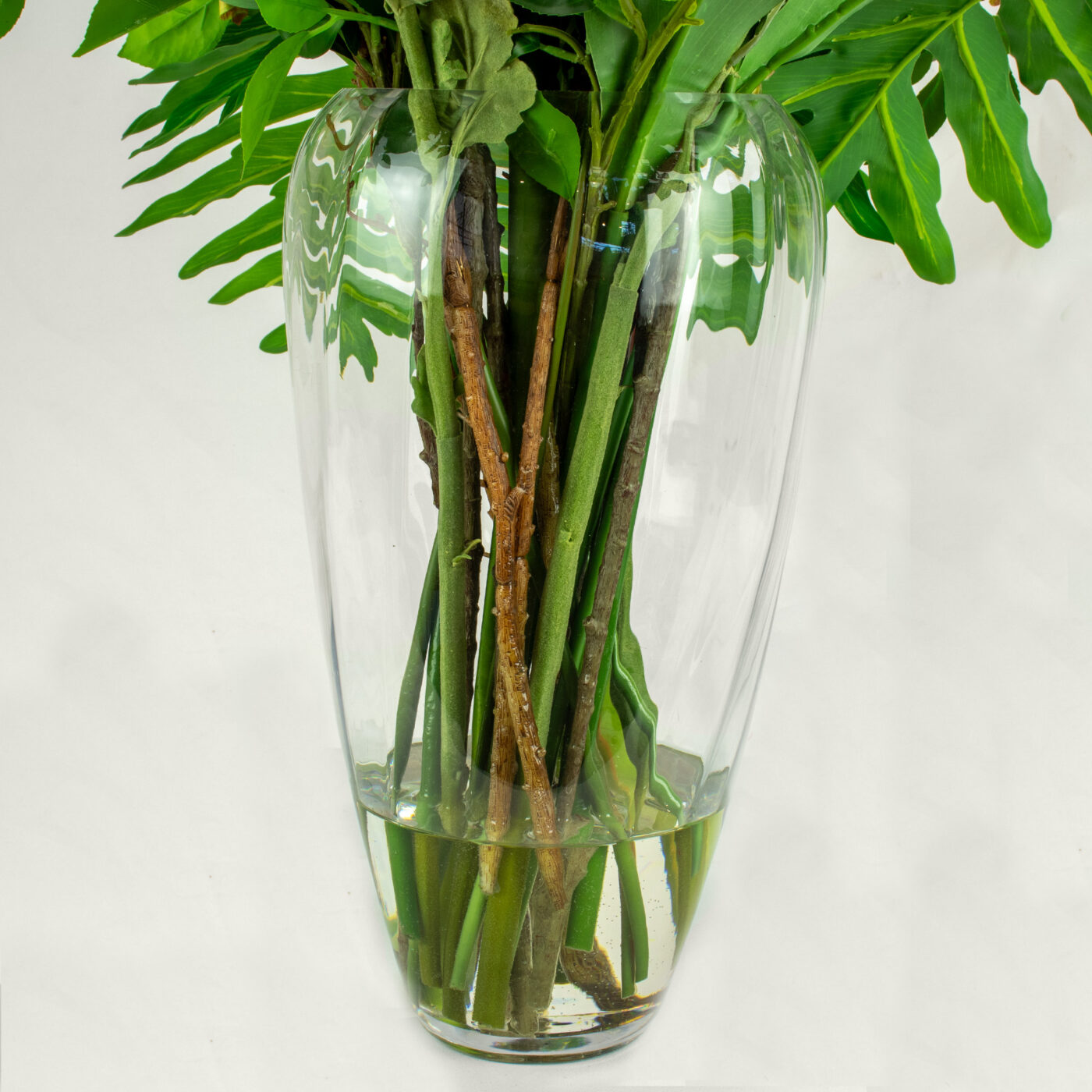 DELUXE LIME AND PINKS WITH FOLIAGE IN GLASS VASE