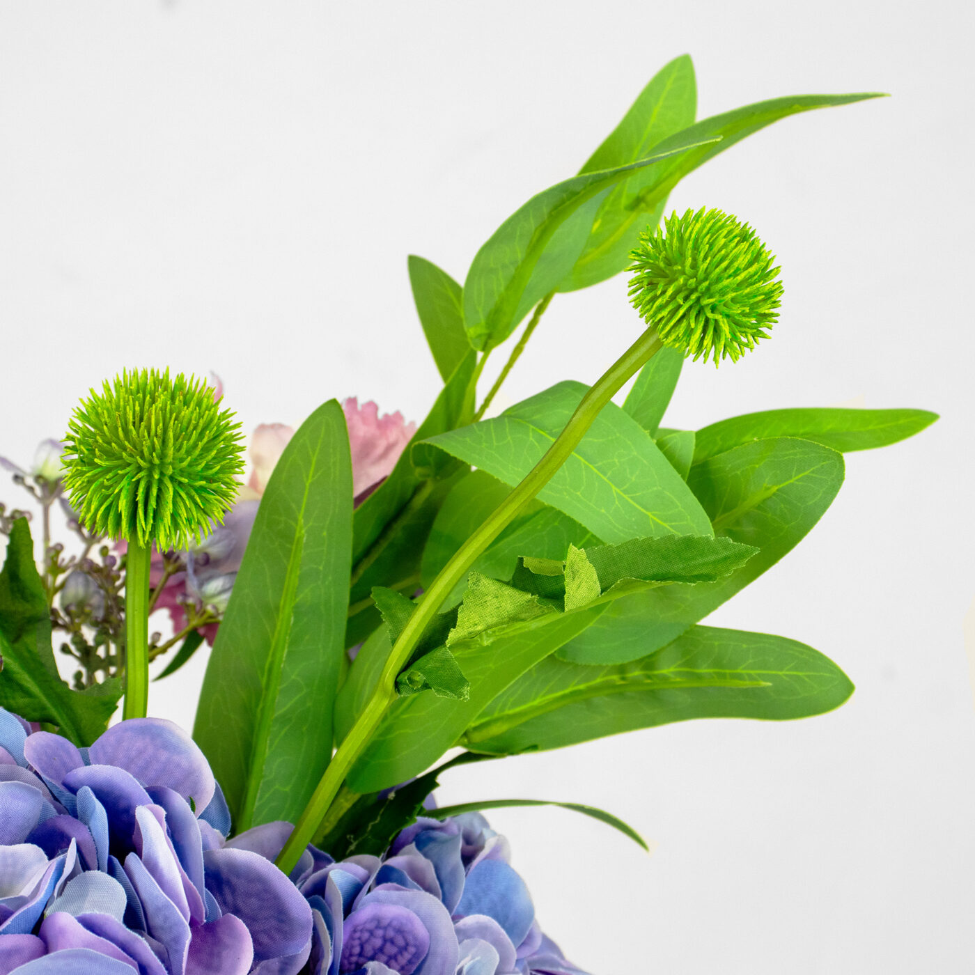 HYDRANGEA BLUE AND PURPLE WITH FOLIAGE IN RIBBED RECT VASE