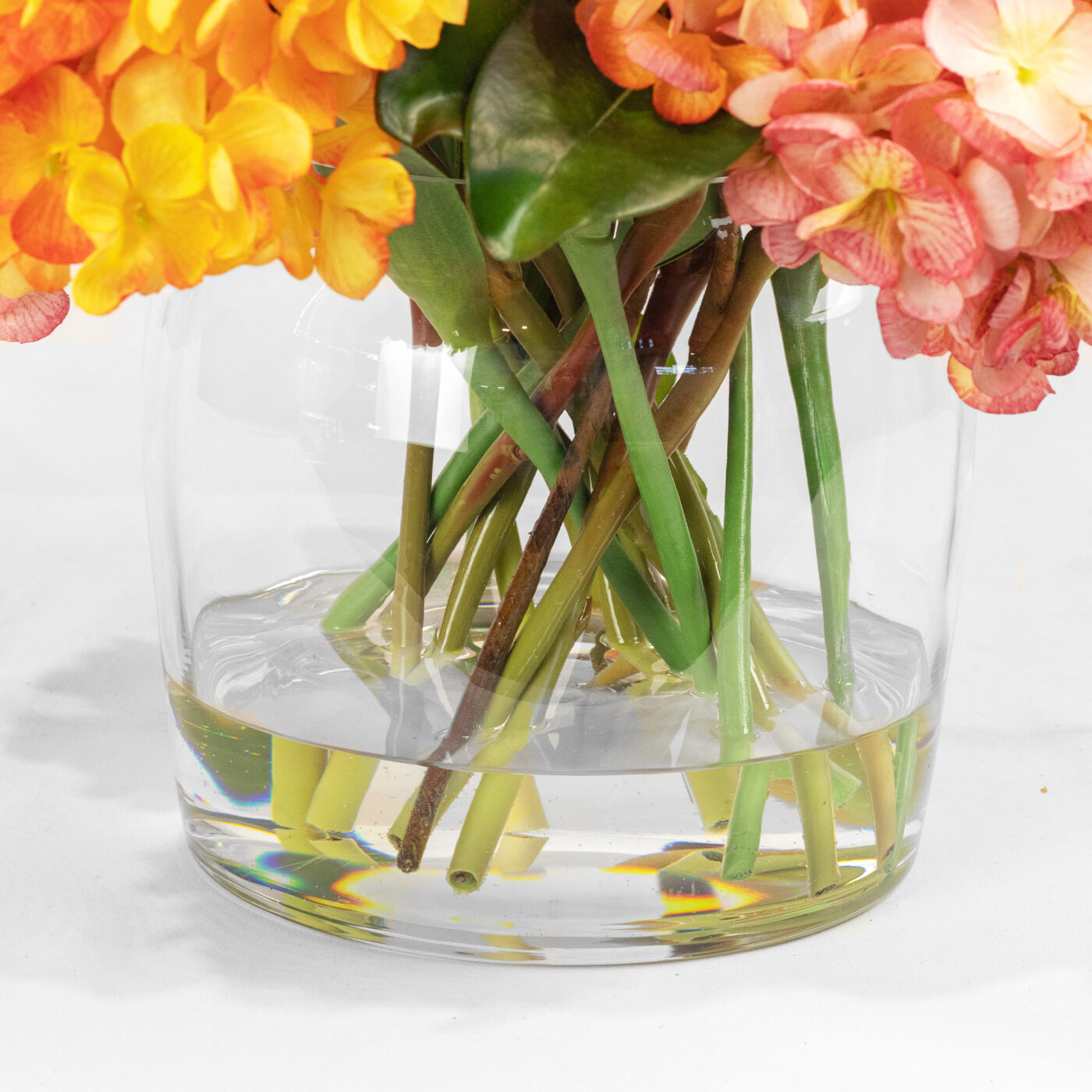 HYDRANGEA ORANGE AND PINK WITH TULIPS IN GLASS VASE