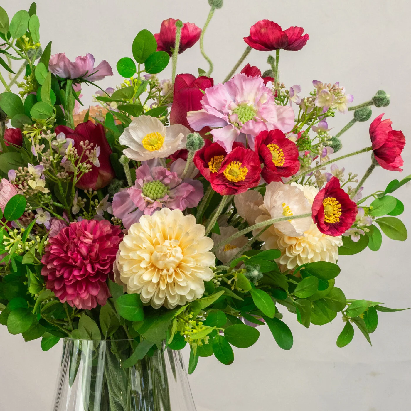 MIXED POPPIES TULIPS AND MUMS IN GLASS VASE