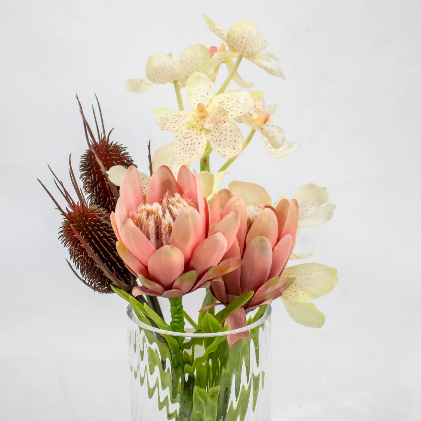 PROTEA CYMBIDIUM AND BANKSIA IN GLASS VASE