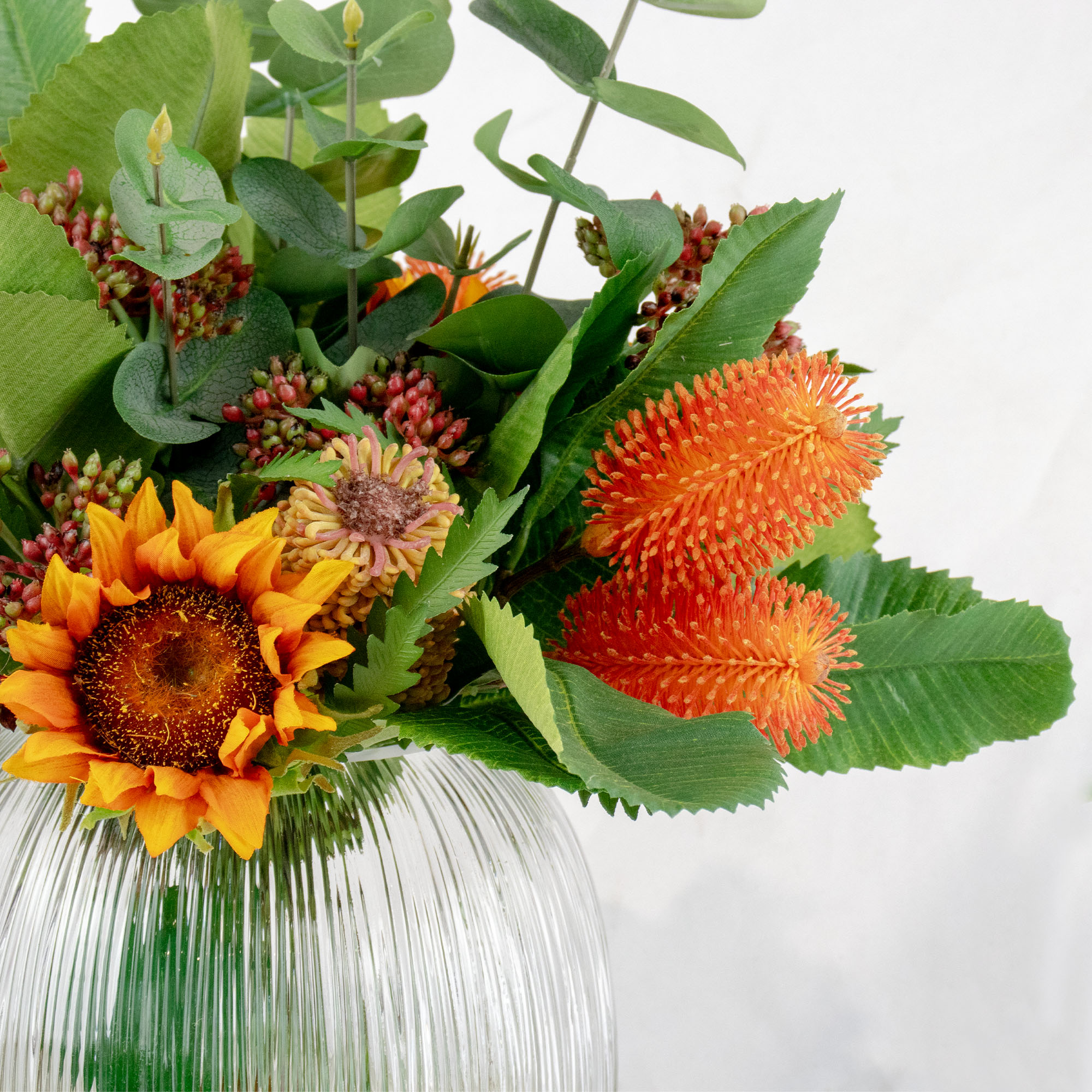 BANKSIA MIX WITH SUNFLOWER IN RIBBED GLASS VASE