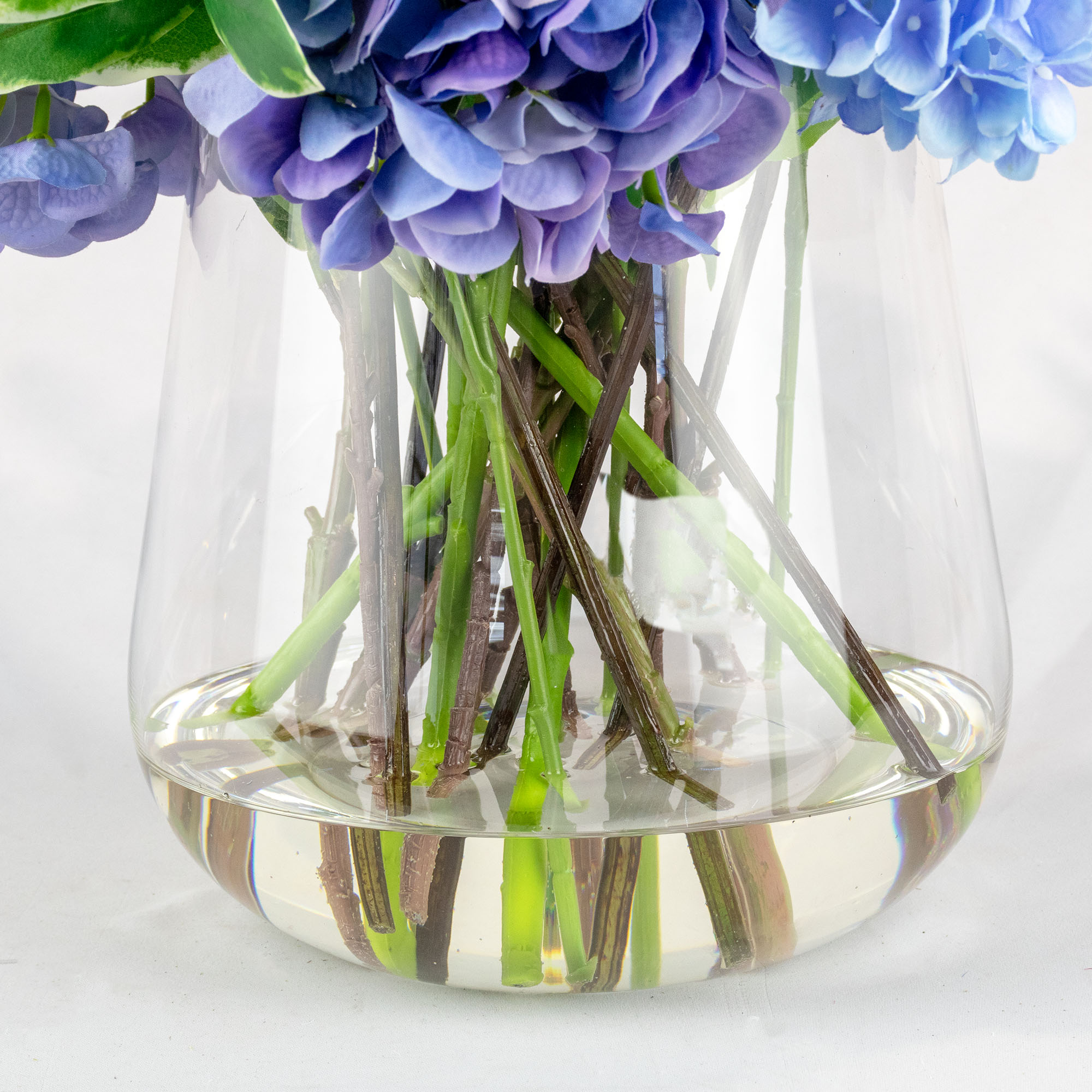 MIXED BLUE HYDRANGEAS IN TULIP VASE