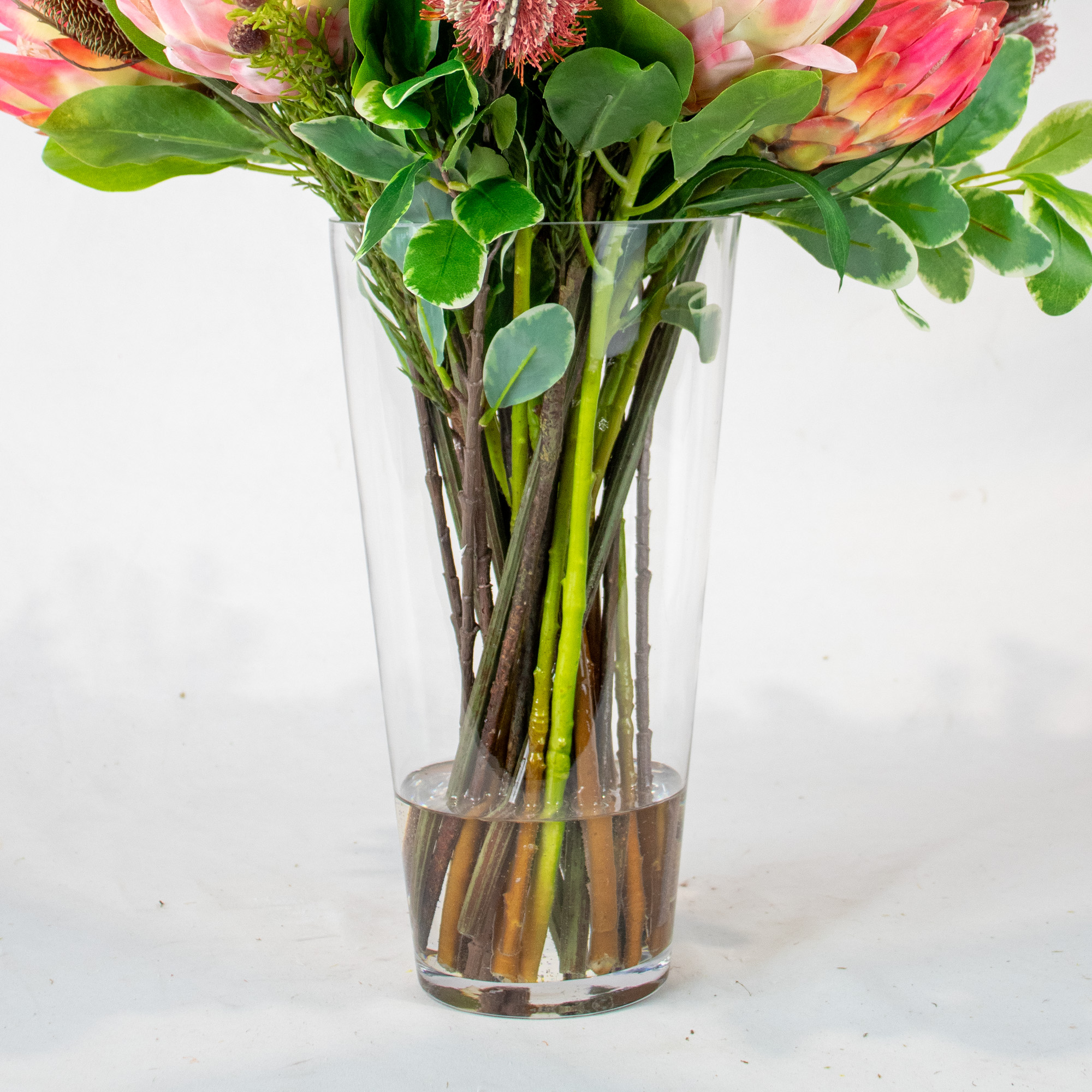 PROTEA MIX WITH PROTEA SPRAY AND FOLIAGE IN CONICAL VASE