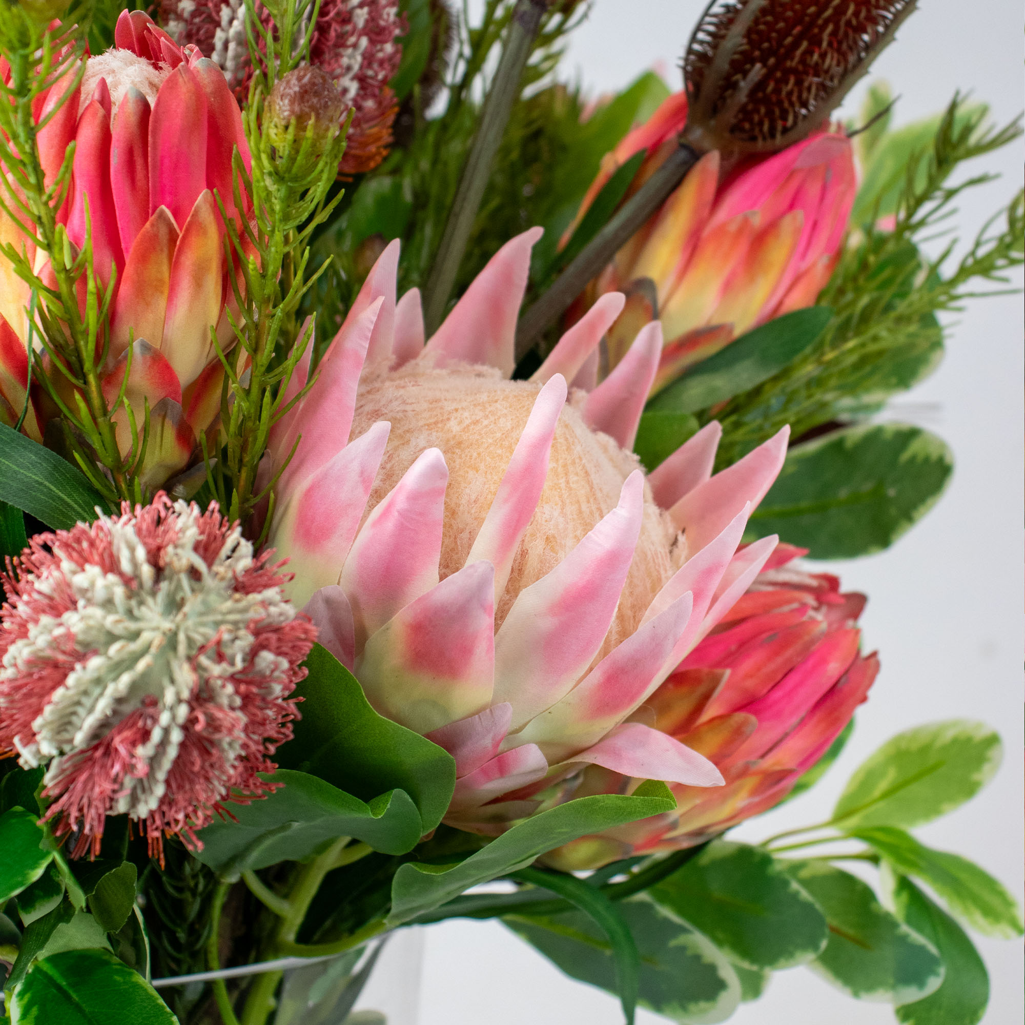 PROTEA MIX WITH PROTEA SPRAY AND FOLIAGE IN CONICAL VASE