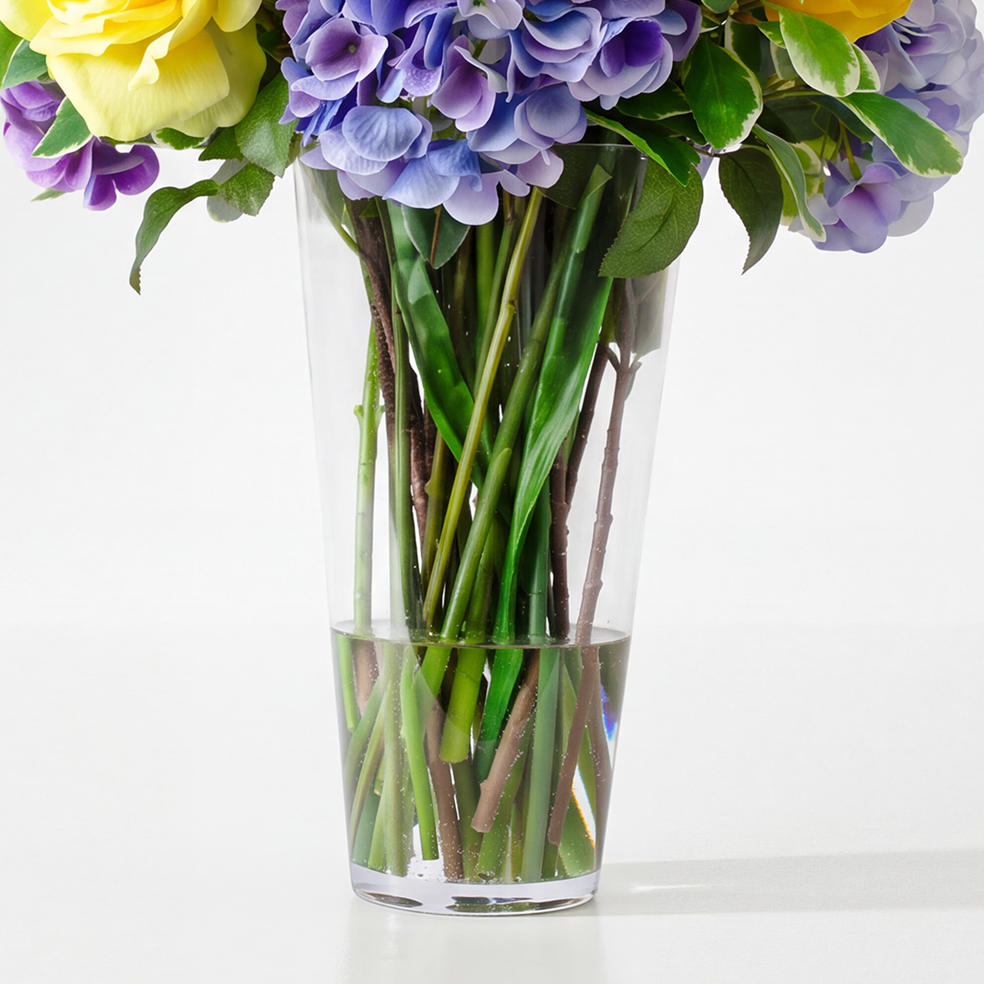 Mixed Yellow And Blue Blooms In Conical Vase