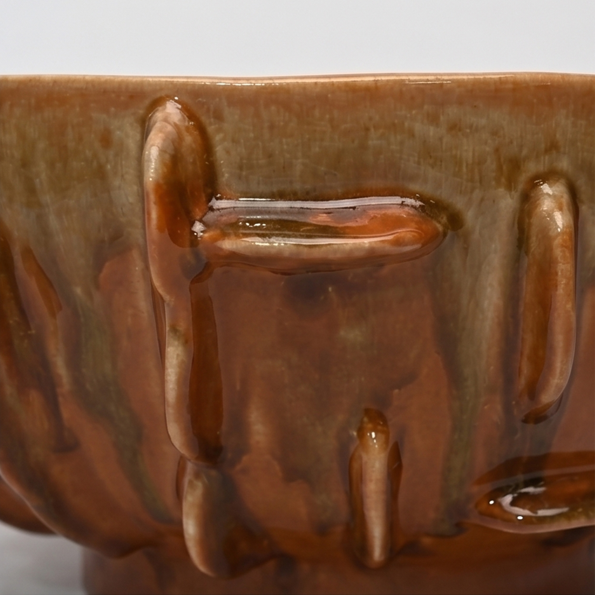 Large 34cm earth drip glaze ceramic bowl with tactile raised ribs sitting on a wide dining table.