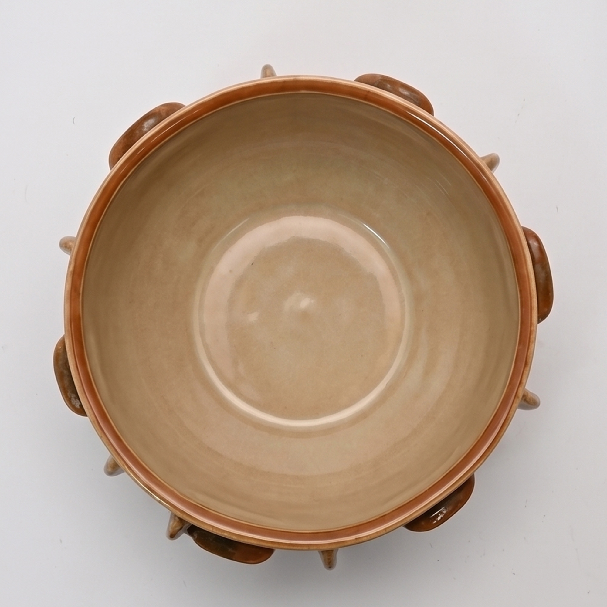 Large 34cm earth drip glaze ceramic bowl with tactile raised ribs sitting on a wide dining table.