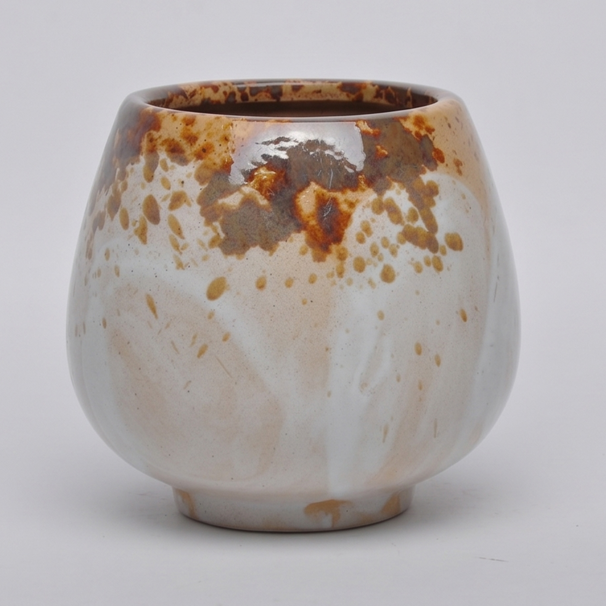 Medium 18cm Nguni speckled ceramic bellied pot with a tactile glazed finish styled on a wooden dining table.