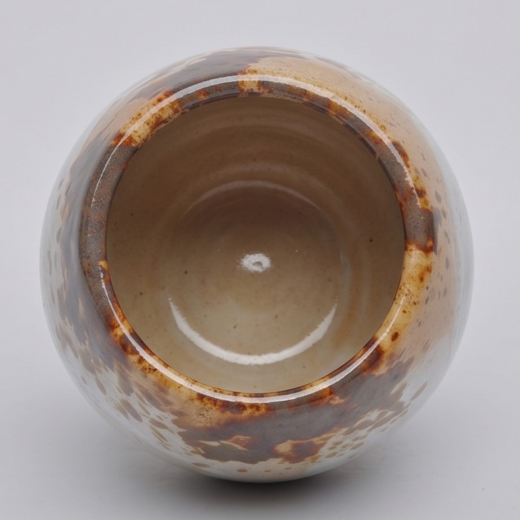 Medium 18cm Nguni speckled ceramic bellied pot with a tactile glazed finish styled on a wooden dining table.