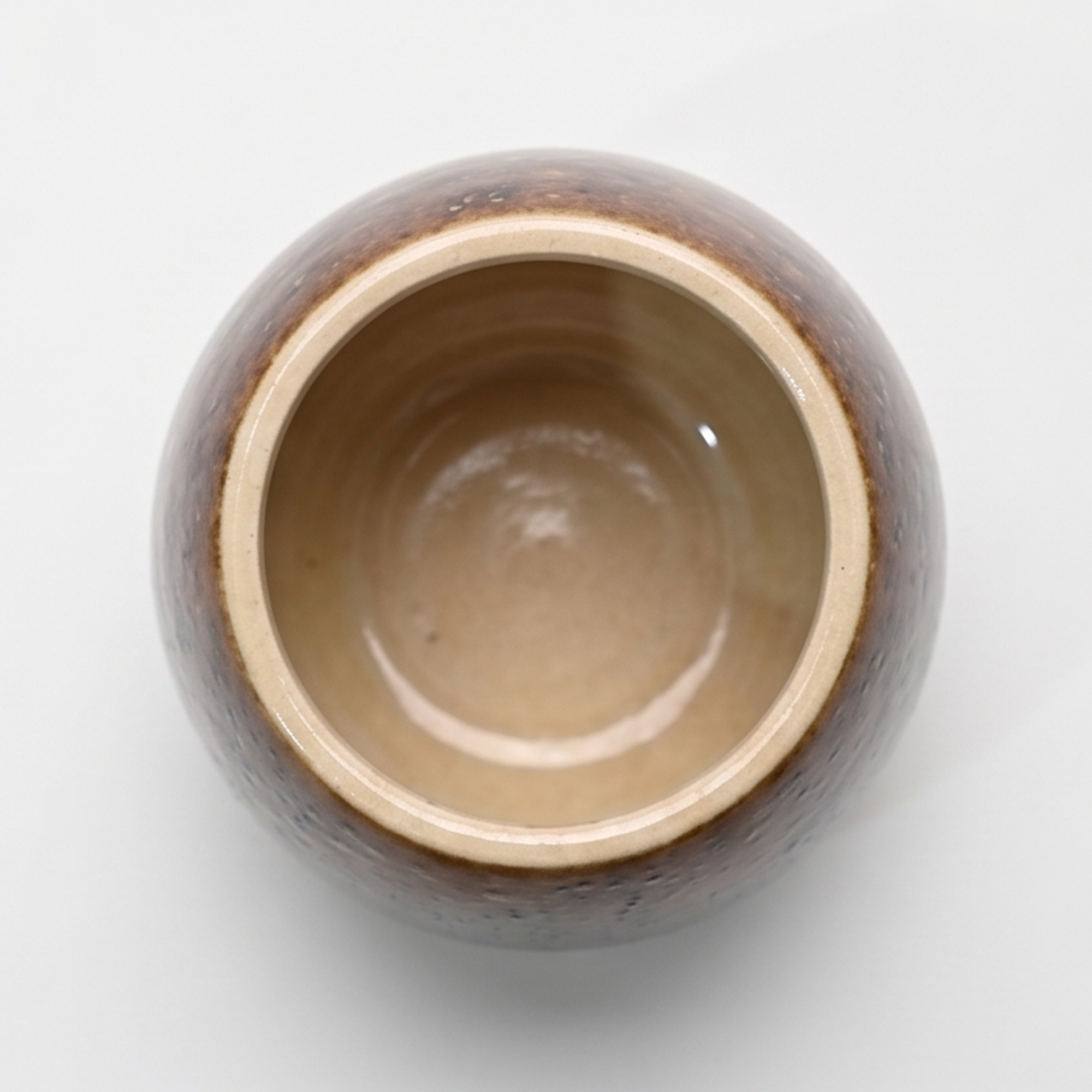 Medium 18cm toffee speckled ceramic bellied pot with a tactile glazed finish styled on a wooden dining table.