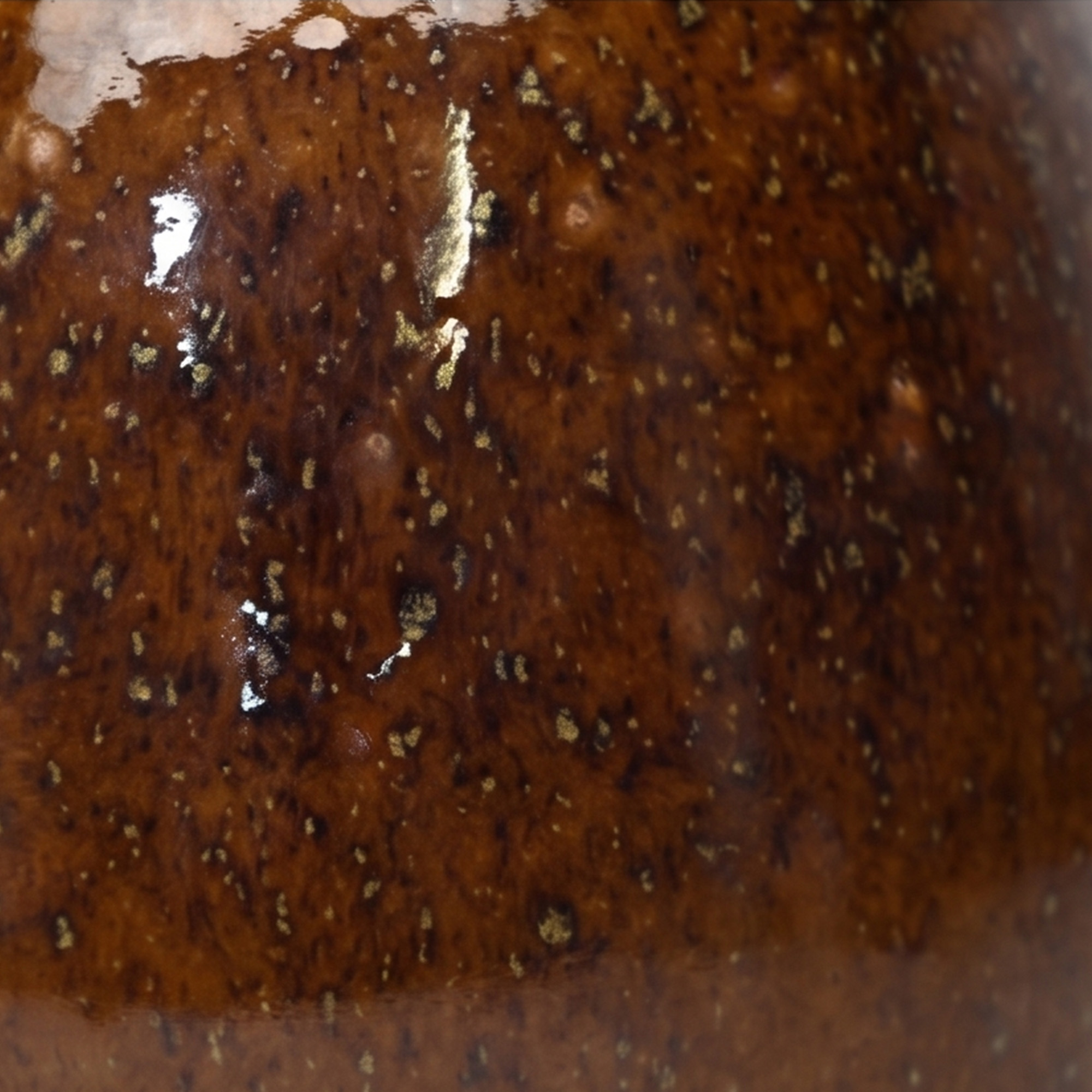 Medium 18cm toffee speckled ceramic bellied pot with a tactile glazed finish styled on a wooden dining table.
