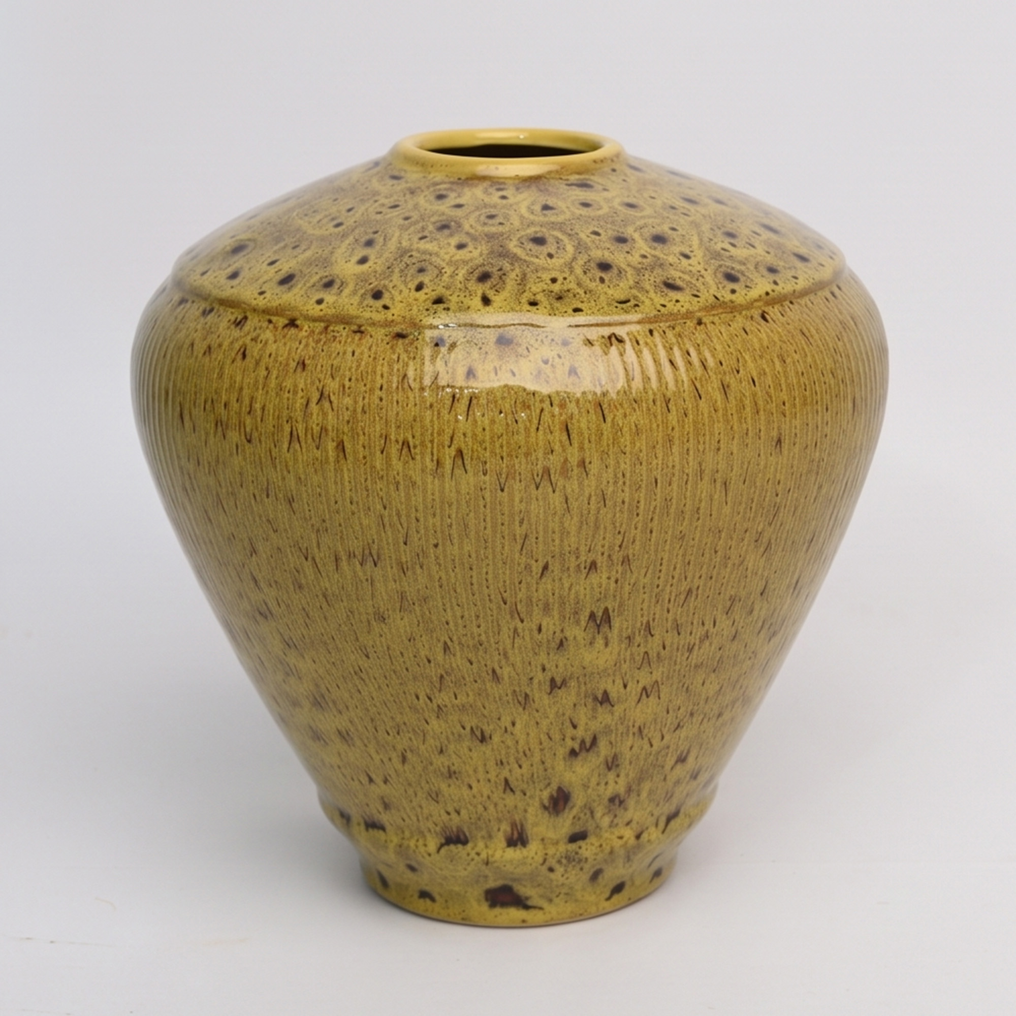 Large 25.5cm leopard spot mustard ceramic jar with a ribbed texture styled on a wooden dining room sideboard.