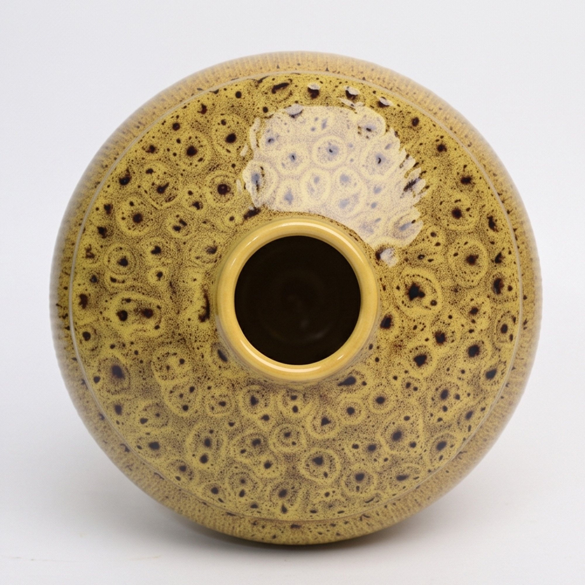 Large 25.5cm leopard spot mustard ceramic jar with a ribbed texture styled on a wooden dining room sideboard.