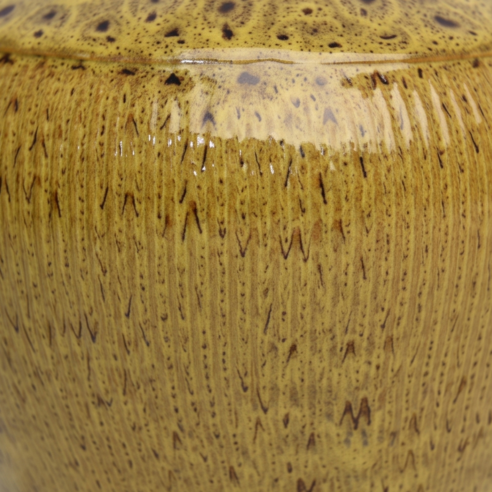 Large 25.5cm leopard spot mustard ceramic jar with a ribbed texture styled on a wooden dining room sideboard.
