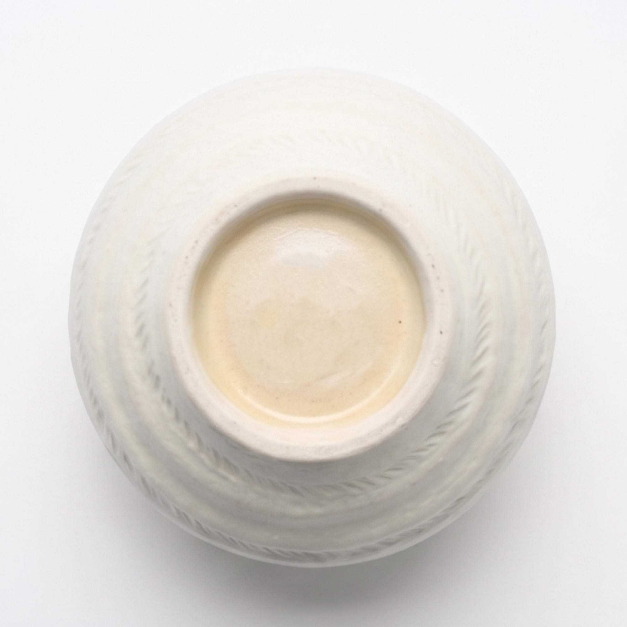 Medium 18.7cm organic gourd off-white ceramic vase with a ribbed texture styled on a wooden dining room sideboard.