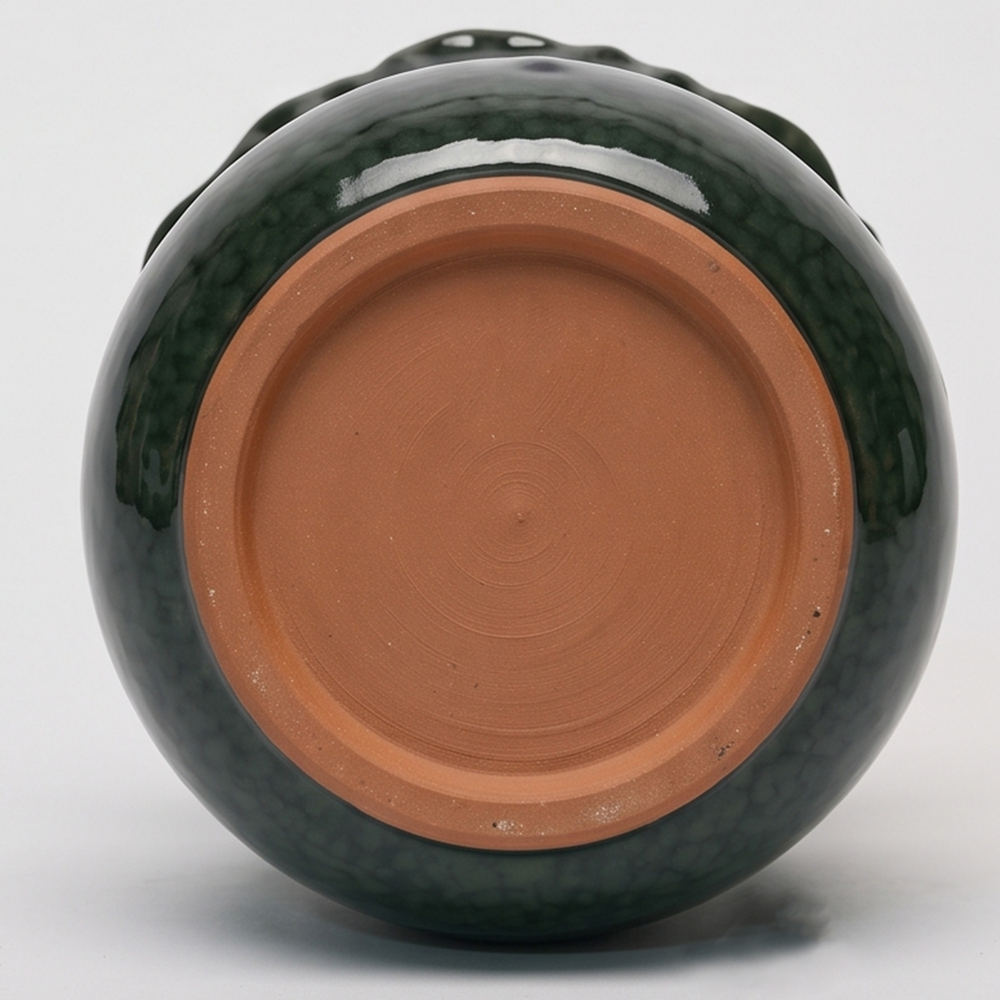 Medium 21.5cm emerald green scalloped ceramic bulbous pot with a fluted rim styled on a wooden entryway console.