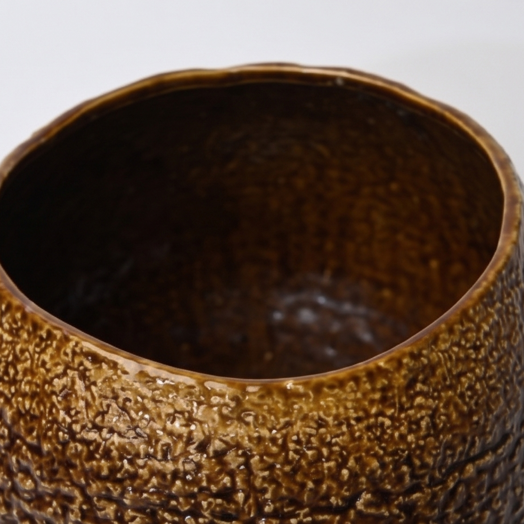 Large 31.5cm textured brown ceramic pedestal bowl vase with a glossy glaze styled on a wooden dining room sideboard.
