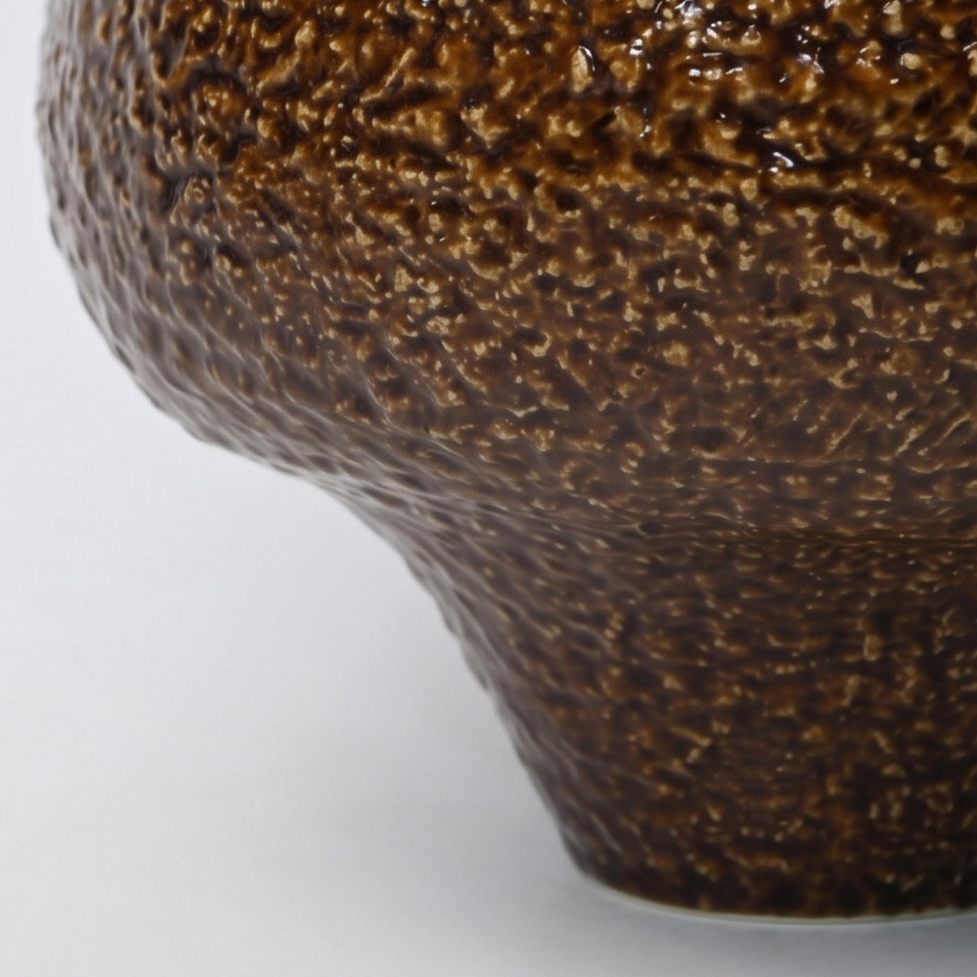 Large 31.5cm textured brown ceramic pedestal bowl vase with a glossy glaze styled on a wooden dining room sideboard.