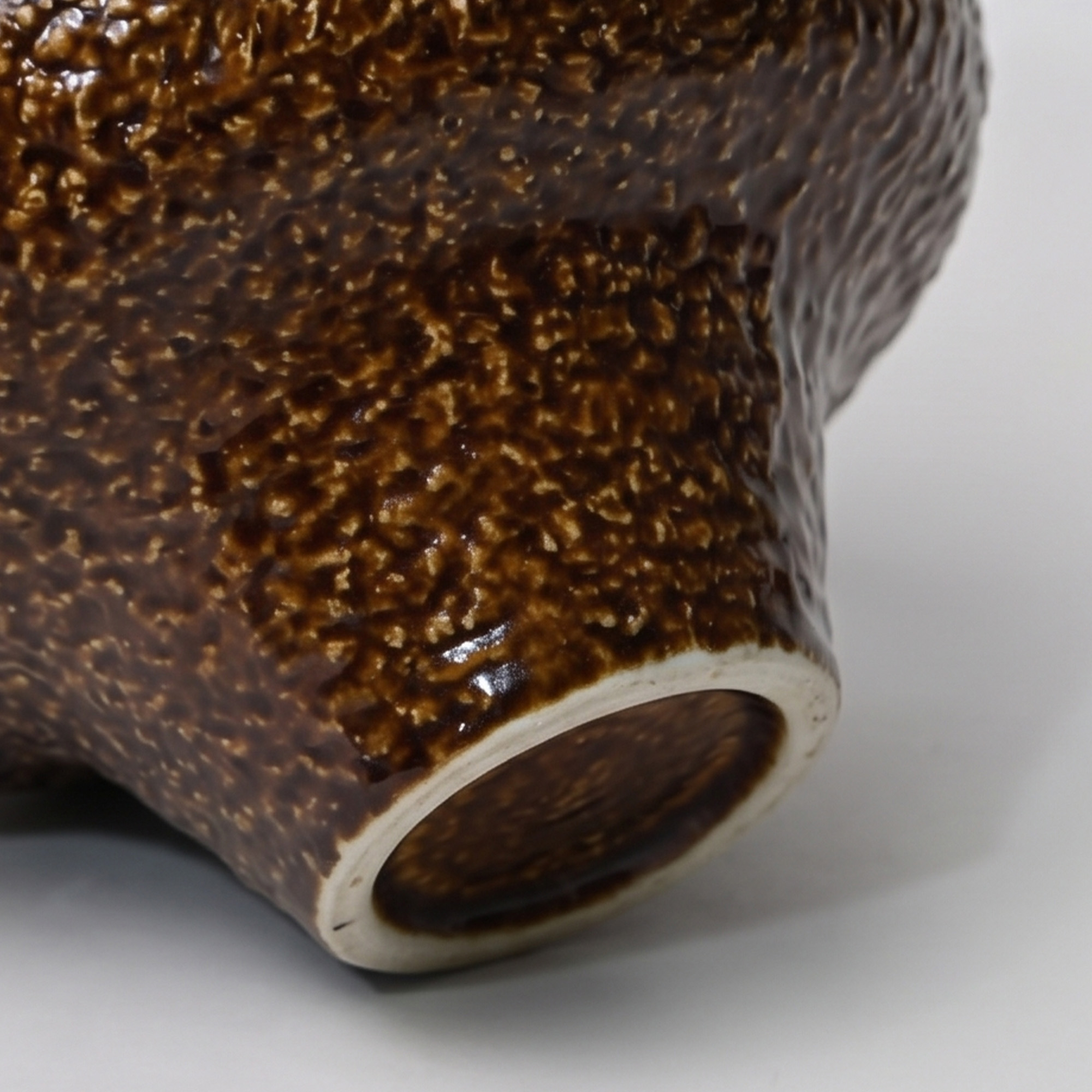 Large 31.5cm textured brown ceramic pedestal bowl vase with a glossy glaze styled on a wooden dining room sideboard.