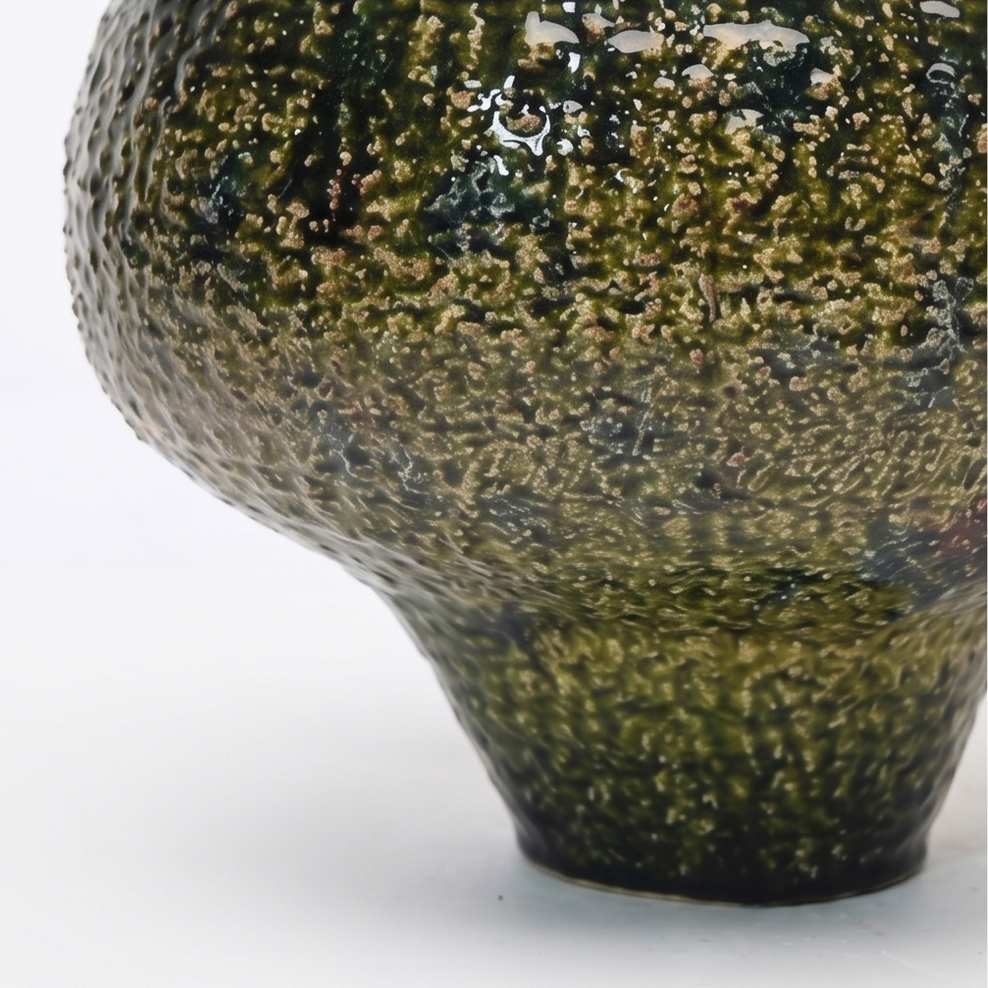 Extra large 31.5cm textured moss green ceramic pedestal bowl vase with a glossy glaze styled on a wooden dining room sideboard.