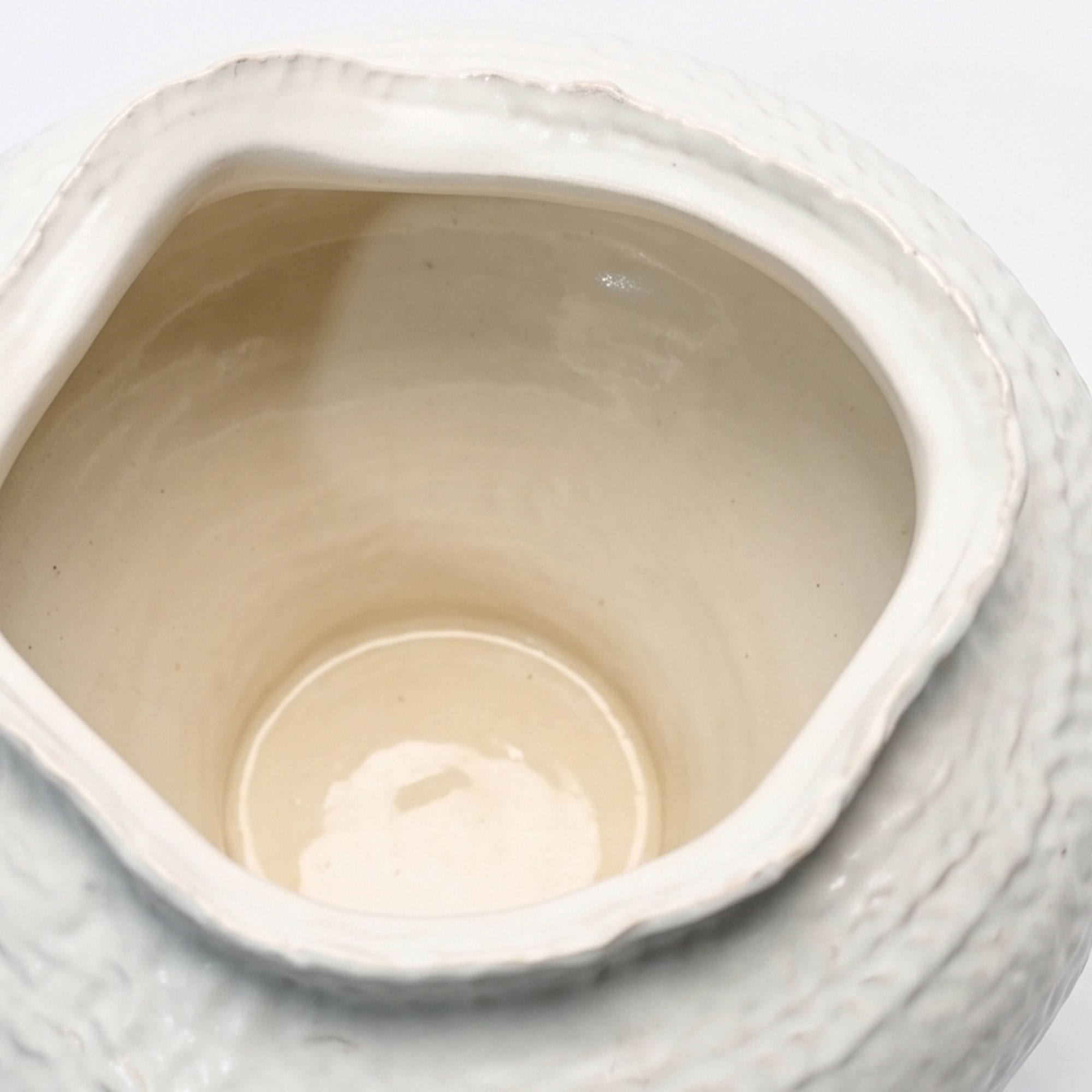 Extra large 36.2cm dimpled white ceramic pedestal vase with a glossy glaze styled on a wooden dining room sideboard.