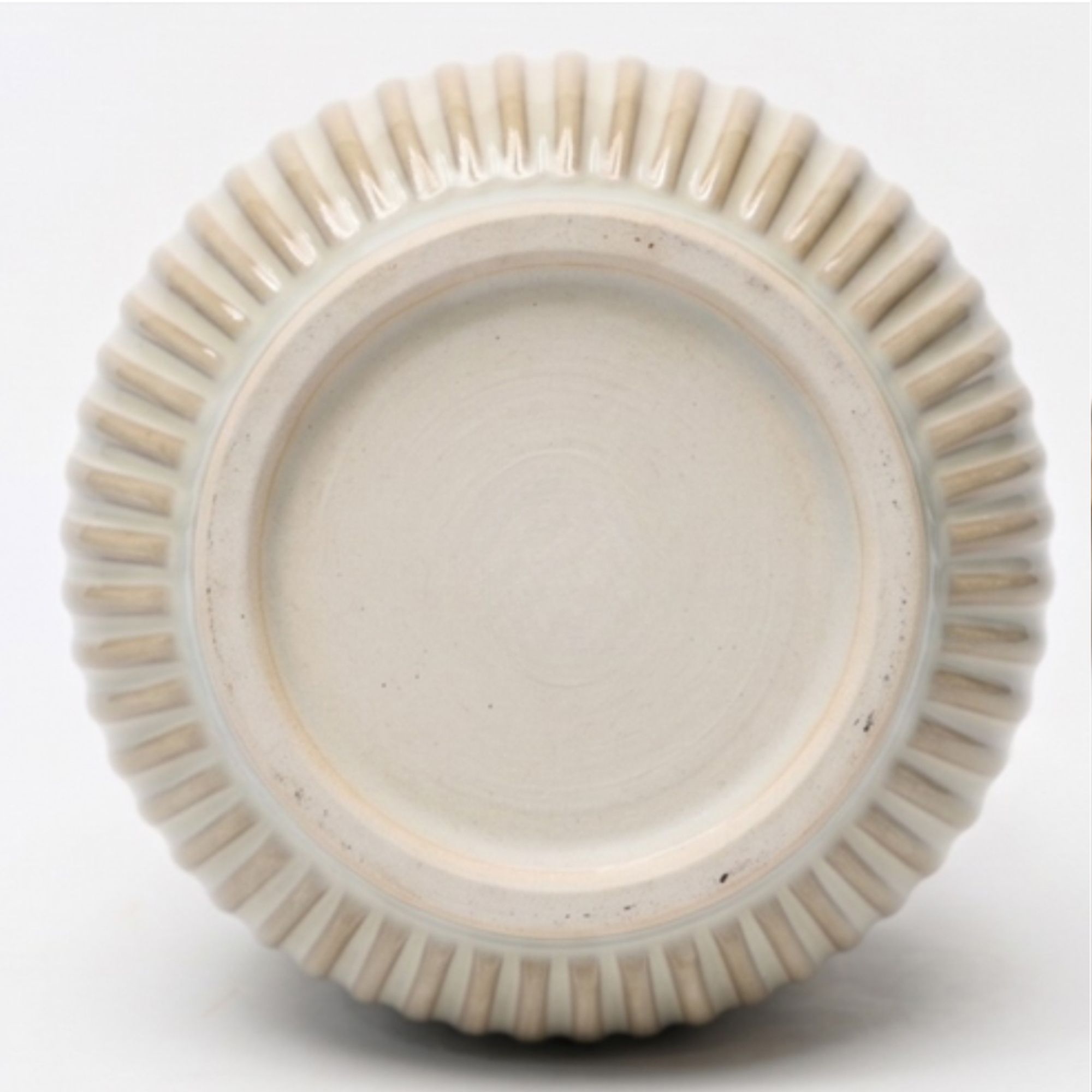 Small 14cm ribbed cream ceramic planter with a rounded base and vertical ribbing styled on a wooden dining room sideboard.