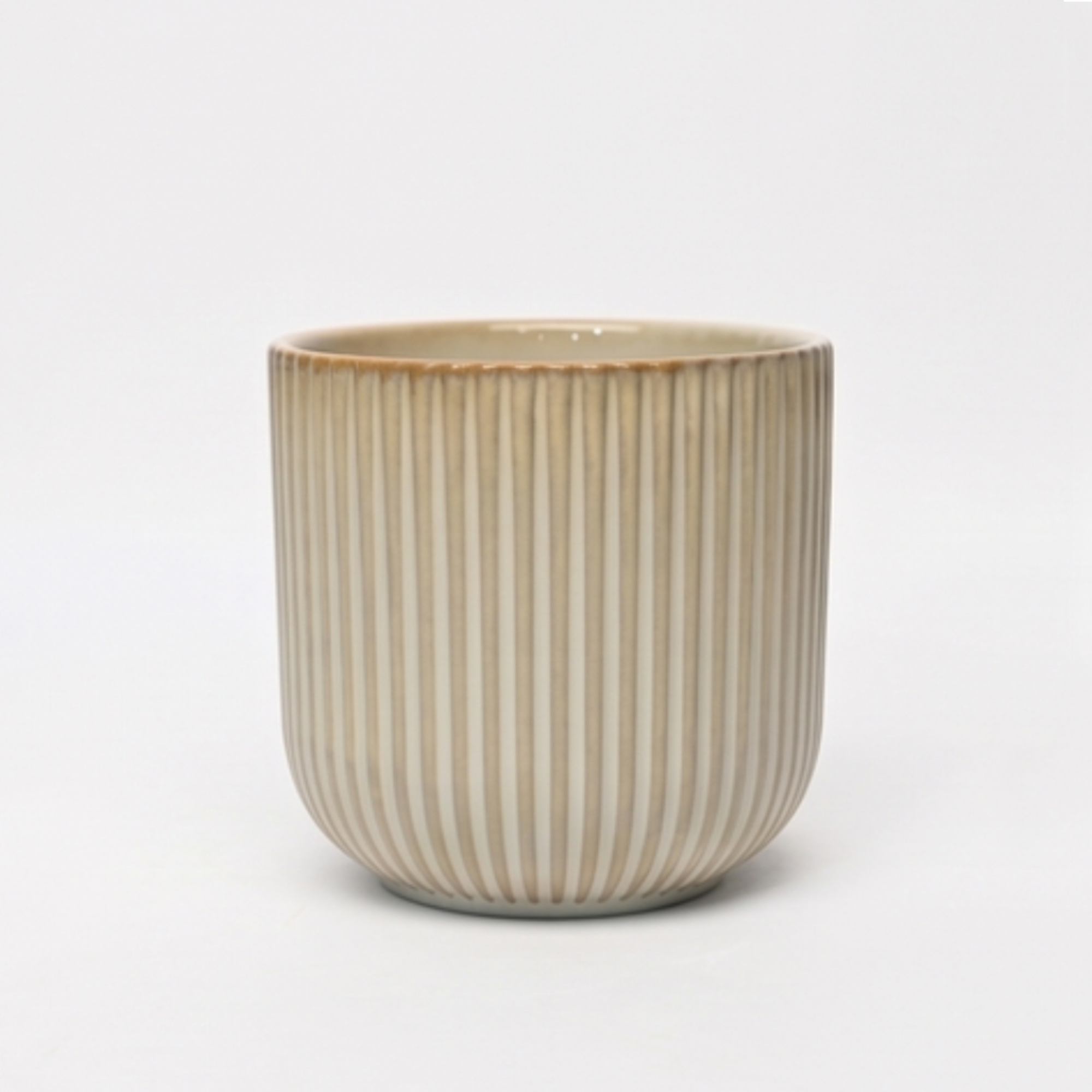 Small 14cm ribbed cream ceramic planter with a rounded base and vertical ribbing styled on a wooden dining room sideboard.