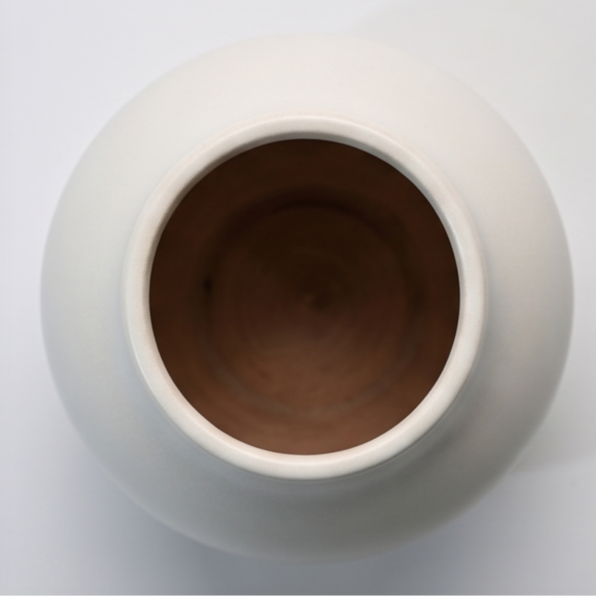 Large 24.5cm classic white ceramic ball vase with a smooth matte finish styled on a wooden dining room sideboard.